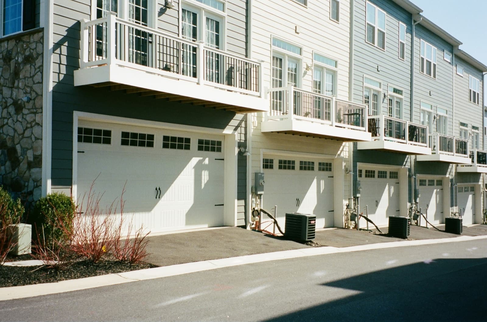 Modern townhomes with large windows and doors