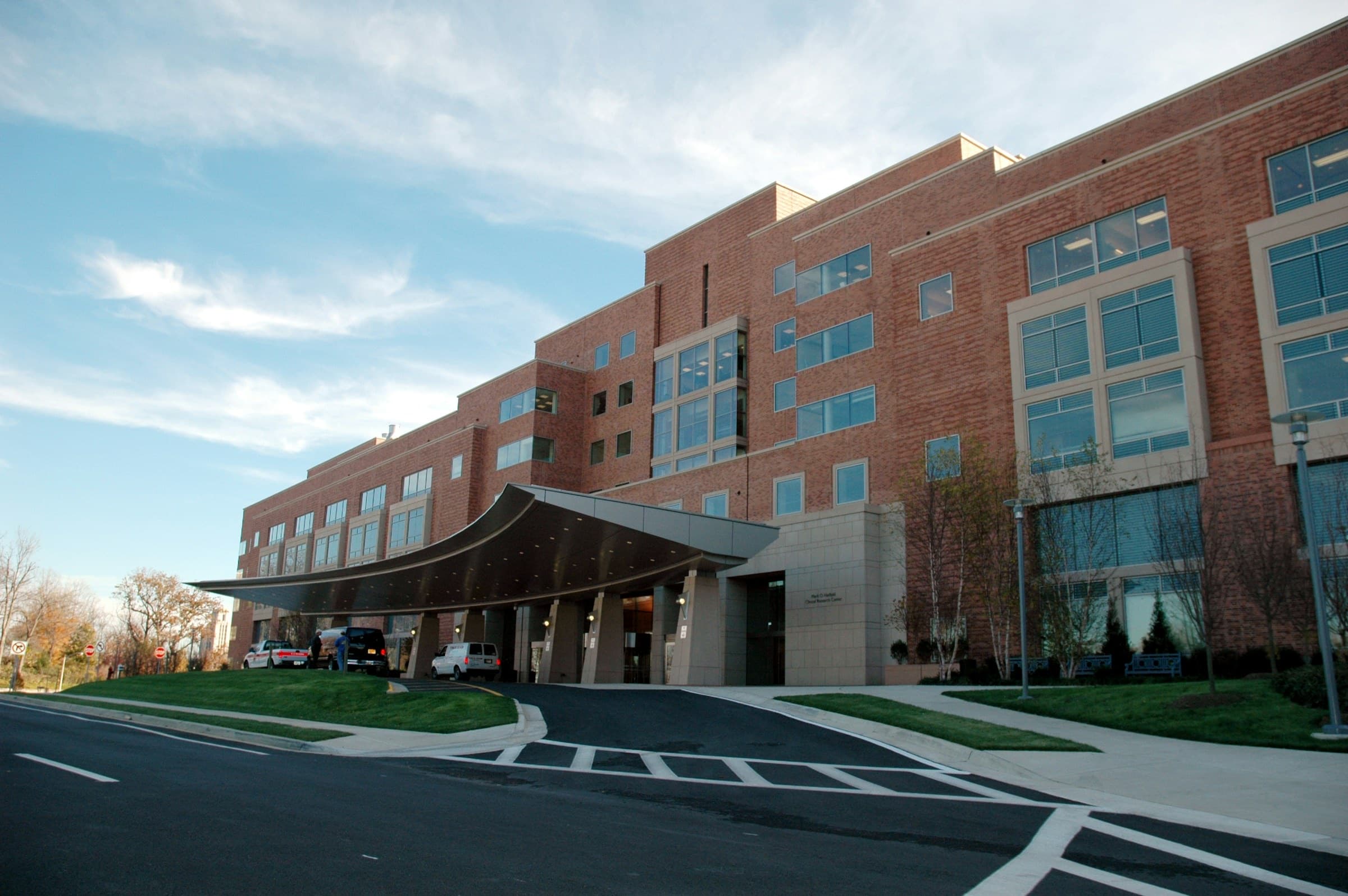 Hospital exterior with patient-room windows and a covered entrance