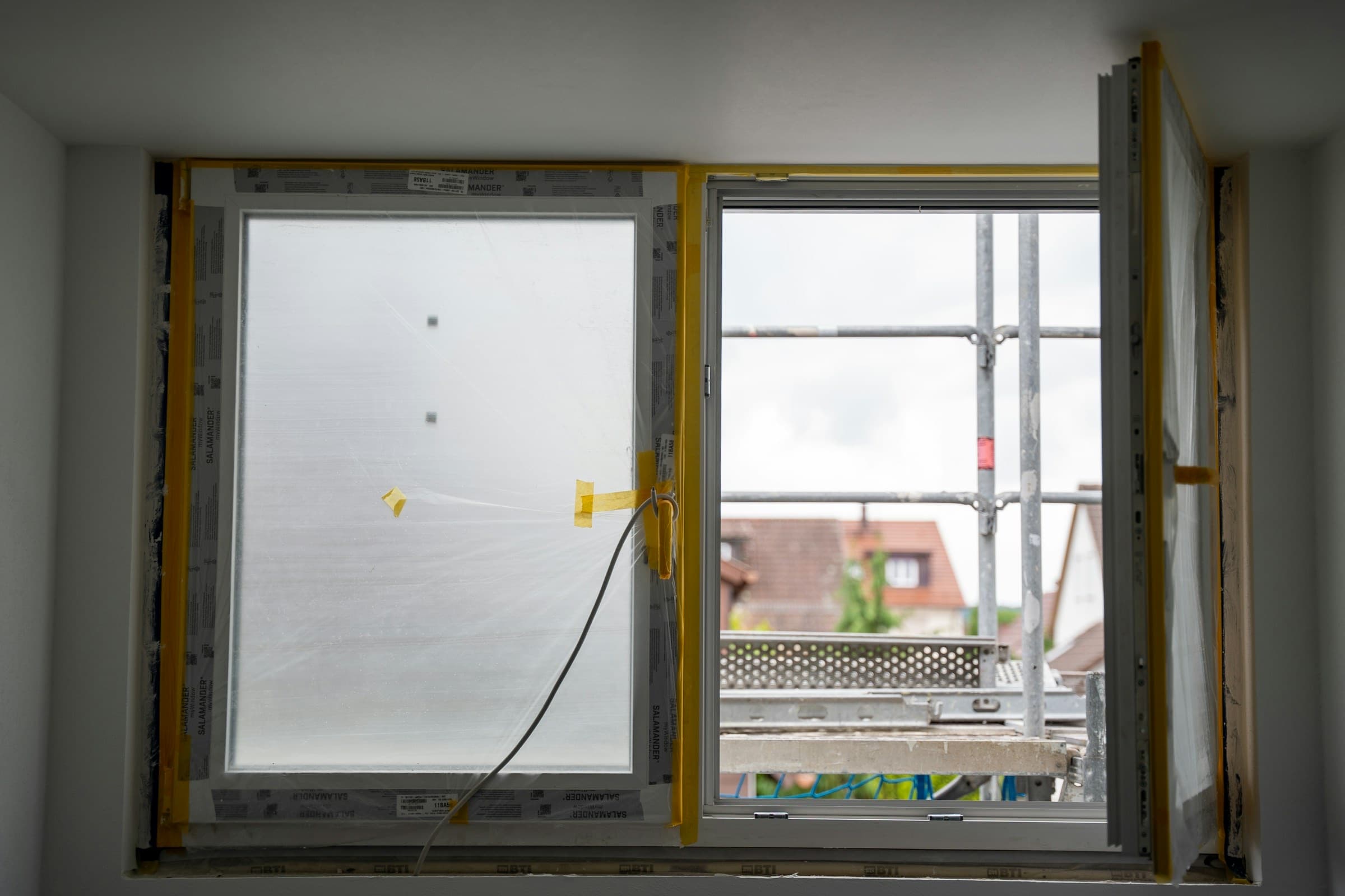 A replacement window being installed in an open wall