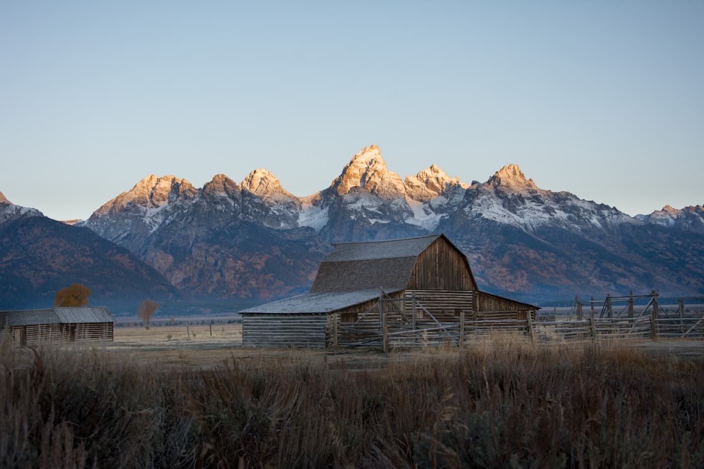 Scenic view of a cabin beneath the Wyoming mountains in Wyoming